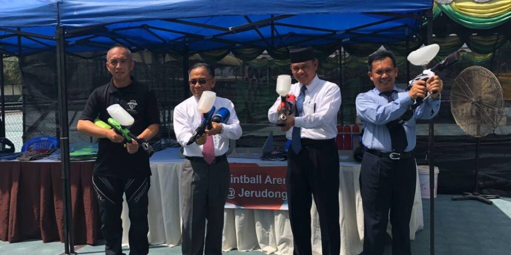 Team celebrating with trophies at Paintball Arena Jerudong event